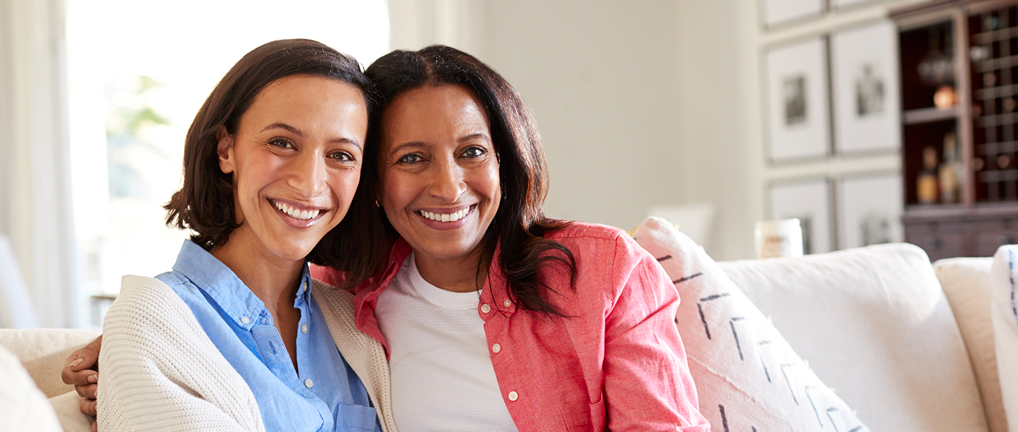 Two adult women sitting on a couch